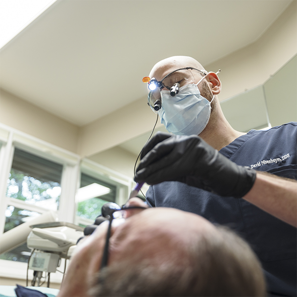 Doctor David giving a patient a dental exam