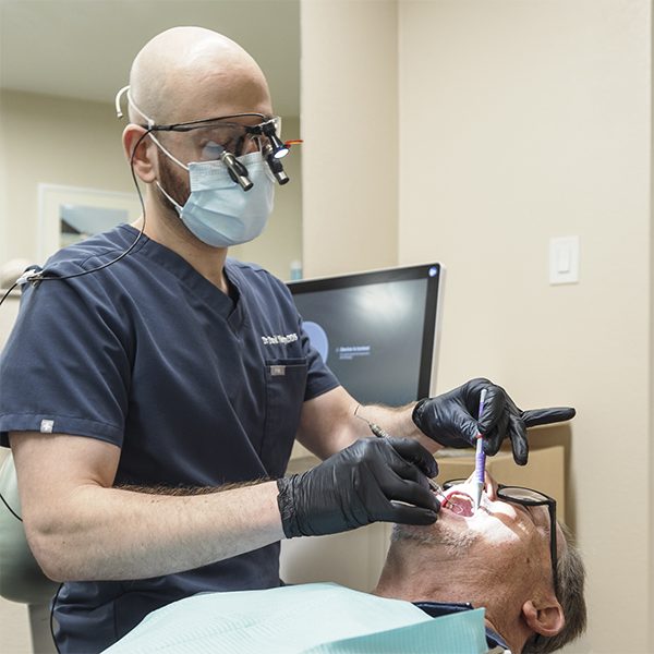 Doctor David examining a patient's teeth