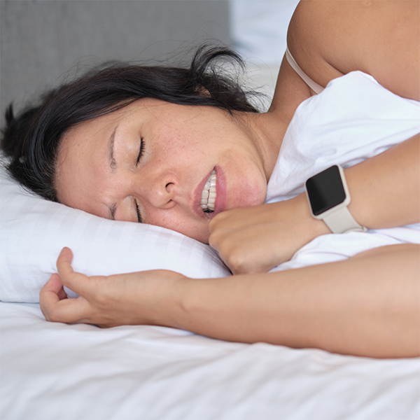 Woman grinding her teeth while she sleeps