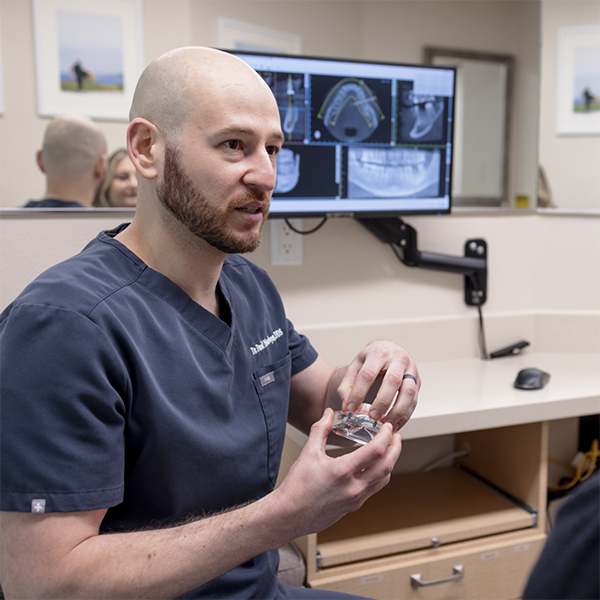 Doctor David talking with a dental patient