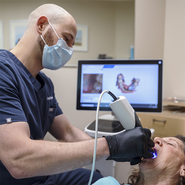 Doctor David taking scans of a patient's teeth