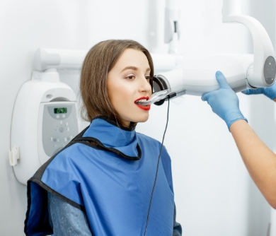 Woman getting her teeth scanned at the dentist