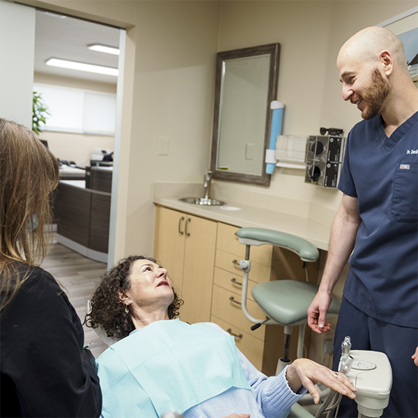 Woman in the dental chair talking to Doctor David
