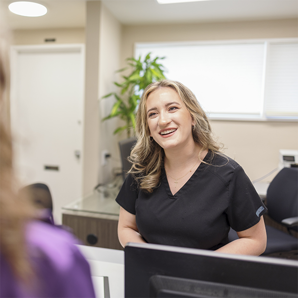 Dental team member greeting a patient