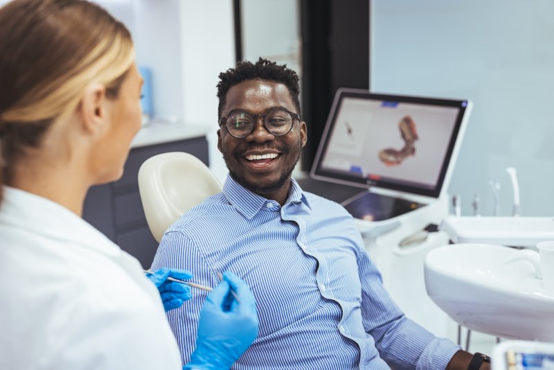 Patient smiling at dentist after getting a dental implant