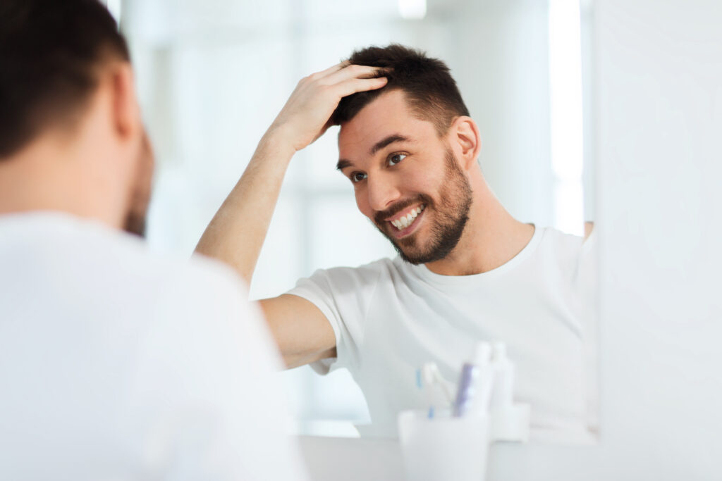Patient looking at their good oral health in the mirror