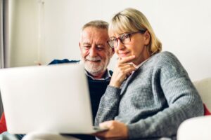 Senior couple doing research on computer 